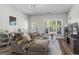 Spacious living room with ample seating, a fireplace, and large windows for natural light at 11255 Wittenridge Dr, Alpharetta, GA 30022