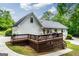 Expansive backyard with large deck, lush greenery, and a well-maintained lawn at 480 Holly Hills Ln, Mcdonough, GA 30252