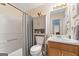 Bathroom with shower-tub combo, storage cabinet and oak vanity at 480 Holly Hills Ln, Mcdonough, GA 30252