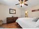 Bedroom featuring hardwood floors, a ceiling fan, and a decorative mirror at 480 Holly Hills Ln, Mcdonough, GA 30252