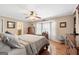 Cozy bedroom featuring hardwood floors, ceiling fan, and a bright window bay at 480 Holly Hills Ln, Mcdonough, GA 30252
