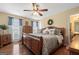 Spacious bedroom with a ceiling fan, hardwood floors, and large windows at 480 Holly Hills Ln, Mcdonough, GA 30252