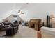 Spacious bonus room/office with plush seating, natural light, and a ceiling fan at 480 Holly Hills Ln, Mcdonough, GA 30252