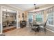 Cozy breakfast nook with three windows and decorative chandelier adjacent to the kitchen at 480 Holly Hills Ln, Mcdonough, GA 30252