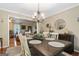 Elegant dining room with seating for six, decorative chandelier and adjacent living room at 480 Holly Hills Ln, Mcdonough, GA 30252
