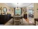 Charming dining room with decorative chandelier, wood floors and stylish decorations throughout at 480 Holly Hills Ln, Mcdonough, GA 30252
