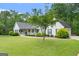 Well-maintained home featuring lush lawn and mature trees, adding curb appeal at 480 Holly Hills Ln, Mcdonough, GA 30252