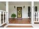 Inviting front porch with decorative wreath and rocking chair for relaxation at 480 Holly Hills Ln, Mcdonough, GA 30252