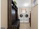 Bright laundry room with washer, dryer, coat rack and storage at 480 Holly Hills Ln, Mcdonough, GA 30252