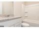 Bathroom showcasing granite countertops, a white tub, and toilet at 279 Oliver Dr, Locust Grove, GA 30248