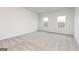 Bright bedroom features neutral carpet, two windows allowing ample natural light at 279 Oliver Dr, Locust Grove, GA 30248
