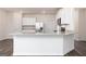 Kitchen island with stainless steel sink and modern faucet, with white cabinets and granite countertop at 279 Oliver Dr, Locust Grove, GA 30248
