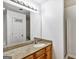 Bathroom boasts wood cabinets, granite counters, and a large mirror above the sink at 547 Se Tufton Se Trl, Atlanta, GA 30354