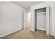 Bright bedroom features a closet with an open door and neutral carpet at 547 Se Tufton Se Trl, Atlanta, GA 30354