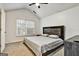 Vaulted ceiling bedroom with a fan, large window, and dark wood furniture at 547 Se Tufton Se Trl, Atlanta, GA 30354