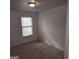 Bright bedroom with natural light from the window, complemented by neutral walls and flooring at 547 Se Tufton Se Trl, Atlanta, GA 30354