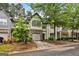 Beautiful townhome features an attached garage, stone accents, and mature trees at 547 Se Tufton Se Trl, Atlanta, GA 30354