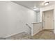 Well-lit carpeted hallway features white walls and staircase with a door at the end at 547 Se Tufton Se Trl, Atlanta, GA 30354