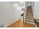Hallway with hardwood floors leading to carpeted stairs at 547 Se Tufton Se Trl, Atlanta, GA 30354