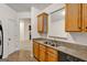 Kitchen features stainless steel sink, tile backsplash, and wood cabinets at 547 Se Tufton Se Trl, Atlanta, GA 30354