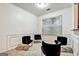 Bright living room features modern decor, neutral walls, and comfortable black, velvet seating at 547 Se Tufton Se Trl, Atlanta, GA 30354