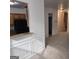 Open living space featuring carpet, wainscoting and a view into the kitchen area with black appliances at 547 Se Tufton Se Trl, Atlanta, GA 30354