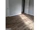 Bedroom with wood flooring and an open doorway at 6260 Marbut Farms Ter, Lithonia, GA 30058