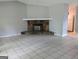 Living room featuring tile floors, fireplace, and a view into the kitchen at 6260 Marbut Farms Ter, Lithonia, GA 30058
