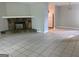Cozy living room with fireplace, tile flooring, and an open view to the kitchen at 6260 Marbut Farms Ter, Lithonia, GA 30058