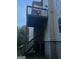 Shows the home's back deck with stairs leading to the yard with a light-colored siding on the home at 10937 Southwood Dr, Hampton, GA 30228