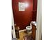 The bathroom features vibrant walls, tile floors, a single sink vanity, and a toilet with paper at 10937 Southwood Dr, Hampton, GA 30228
