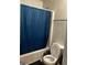 Bathroom with toilet, tub and blue shower curtain at 10937 Southwood Dr, Hampton, GA 30228
