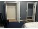 A bedroom with an open closet, a chair and an open doorway at 10937 Southwood Dr, Hampton, GA 30228