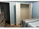 Light blue bedroom featuring an open closet with wire rack and ample storage space at 10937 Southwood Dr, Hampton, GA 30228