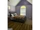 Bedroom with purple walls, high ceilings and neutral and red patterned rug at 10937 Southwood Dr, Hampton, GA 30228