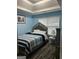Light blue bedroom featuring a comfortable bed and natural light from a window at 10937 Southwood Dr, Hampton, GA 30228