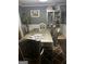 Dining room boasts stylish furniture, wood floors, and neutral paint at 10937 Southwood Dr, Hampton, GA 30228