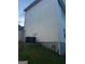 Shows the side of the home with light siding and a glimpse of an elevated deck and the home's HVAC system at 10937 Southwood Dr, Hampton, GA 30228