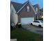 This is a two-story brick home with a two-car garage and manicured front lawn at 10937 Southwood Dr, Hampton, GA 30228