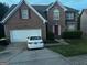 Two-story brick home featuring a two-car garage, driveway, and well-maintained front yard at 10937 Southwood Dr, Hampton, GA 30228
