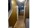 Hallway view showcases the tile flooring leading to a kitchen with wood cabinets and updated countertops at 10937 Southwood Dr, Hampton, GA 30228