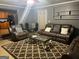 A cozy living room with a brown leather sofa set, patterned rug, and modern decor at 10937 Southwood Dr, Hampton, GA 30228