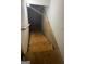 Staircase leading down with wooden steps and a handrail, transitioning to an unfinished basement at 10937 Southwood Dr, Hampton, GA 30228