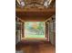 Interior barn view showcasing horse stalls, dirt floors, and bright landscape beyond at 228 Indian Creek Rd, Locust Grove, GA 30248
