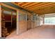 A set of wooden horse stalls in the bright interior of a barn with a sand floor at 228 Indian Creek Rd, Locust Grove, GA 30248