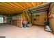 View of multiple horse stalls with wooden doors inside a spacious barn with dirt floor at 228 Indian Creek Rd, Locust Grove, GA 30248