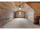 Bonus room boasts wood paneling, carpet, and a ceiling fan at 228 Indian Creek Rd, Locust Grove, GA 30248
