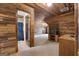 Upper room featuring rustic wood walls, carpeted floor, and ample space for a variety of uses at 228 Indian Creek Rd, Locust Grove, GA 30248