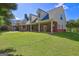 Charming home boasts a spacious covered porch perfect for outdoor living and enjoying the serene surroundings at 228 Indian Creek Rd, Locust Grove, GA 30248