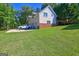 Spacious garage with multiple bays and stone accents, set against a lush green lawn and mature trees, a car is parked outside at 228 Indian Creek Rd, Locust Grove, GA 30248